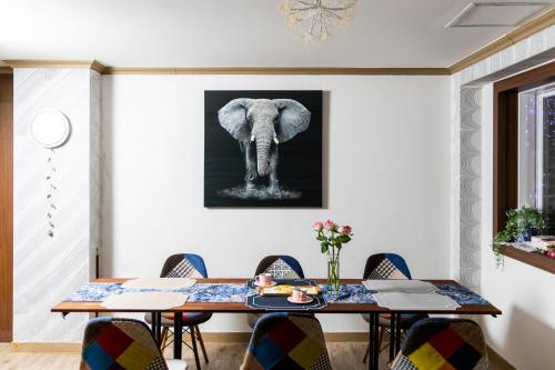 a dining room with an elephant picture on the wall at Buan Tree California Hotel in Buan