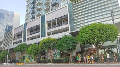 a group of people standing in front of a building at Mactan Newtown Beach Condo in Mactan