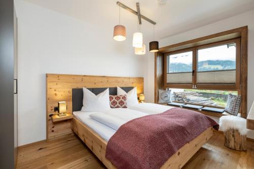 a bedroom with a large bed and a window at Holzlodge deluxe in Radstadt