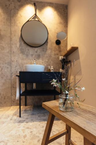 a bathroom with a sink and a mirror on the wall at Hilburger Hotel in Schenna
