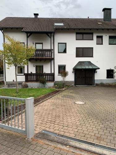 a large white house with a brick driveway at Eisenbahn in Rheinmunster