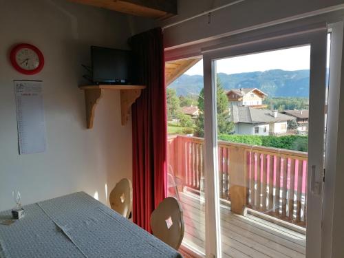 a room with a view of a balcony at Giongo Residence - Appartamenti in Lavarone