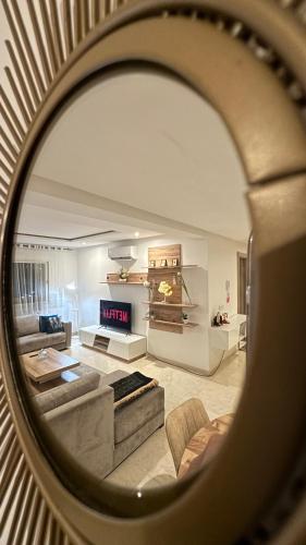 a view of a living room through a mirror at Luxury Family Appart 7 Pers - CheckPoint - Oujda Center in Oujda