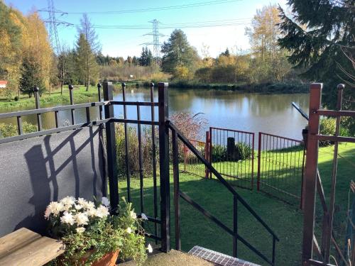 a gate leading to a river with a fence at Nad stawami in Wilka