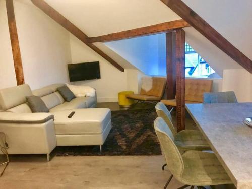 a living room with a couch and a table at The Penthouse in Windermere in Windermere