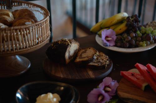 a table topped with plates of bread and fruit at Hotel Hort De Fortunyo in Arnés