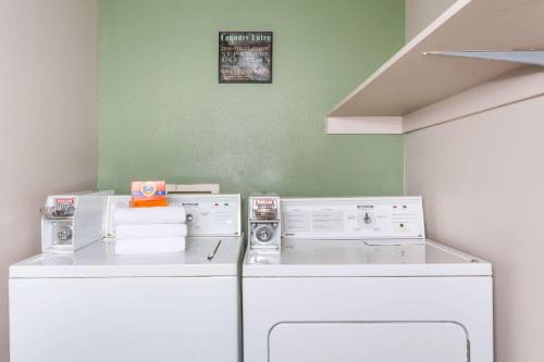 a laundry room with a washer and dryer at Super 8 by Wyndham Rock Springs in Rock Springs
