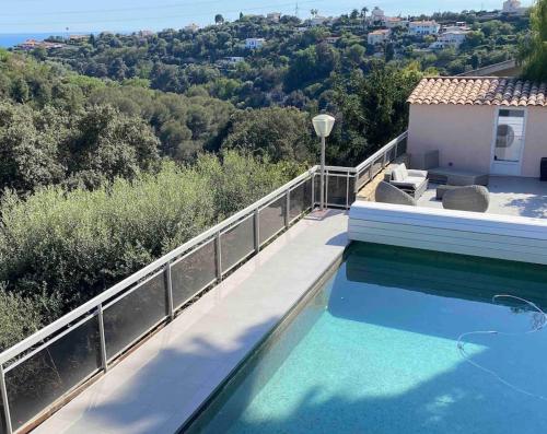 une maison avec une piscine à côté d'un bâtiment dans l'établissement Magnifique villa familiale avec piscine, à Nice