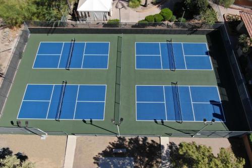 an overhead view of four tennis courts with blue nets at Hilton Phoenix Tapatio Cliffs Resort in Phoenix