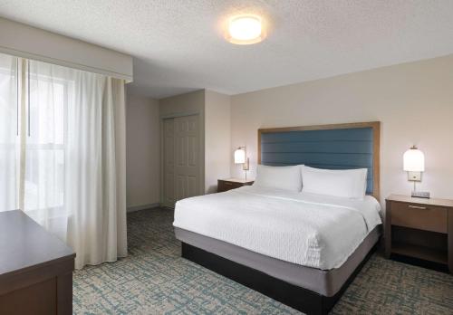 a hotel room with a bed and a window at Homewood Suites by Hilton Lake Mary Orlando North in Lake Mary