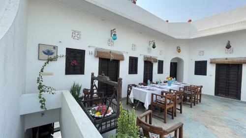 a dining room with a table and chairs at Mosaics Guest House in Jaipur