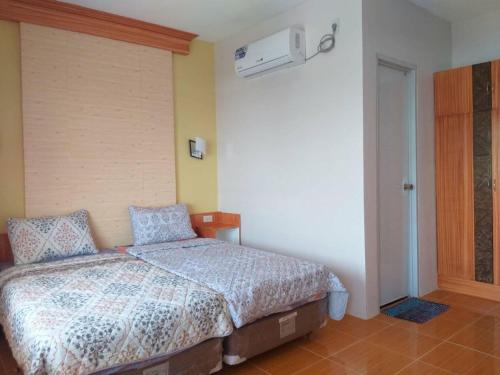 een slaapkamer met een bed met blauwe kussens erop bij Azzura Hotel in Zamboanga