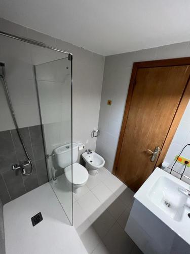 a bathroom with a toilet and a sink and a shower at Apartamento Portobello in Port de Pollensa