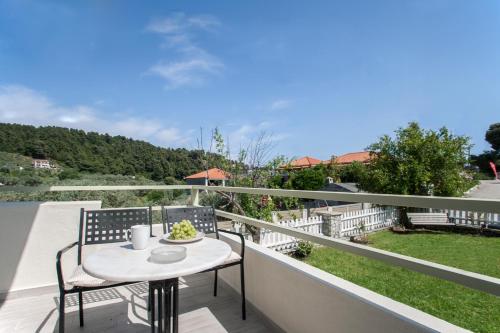a table and chairs on a balcony with a view at Alexia Studios in Kolios