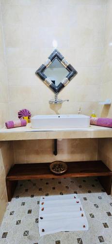a bathroom with a sink and a mirror at Riad Amazing in Marrakech