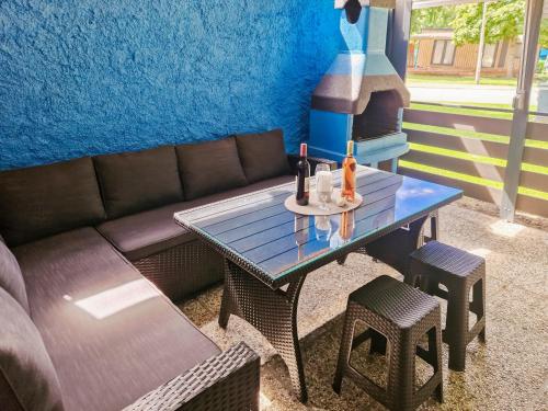 a table with a couch and a table with drinks on it at Aparthouse SUPREME with Terme Catez Swimming Pools Tickets in Čatež ob Savi