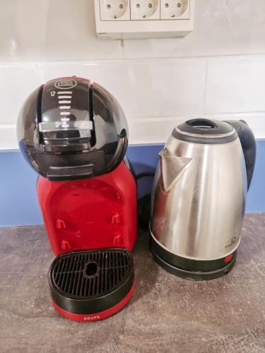 a toaster sitting on a counter next to a coffee maker at Aparthouse SUPREME with Terme Catez Swimming Pools Tickets in Čatež ob Savi