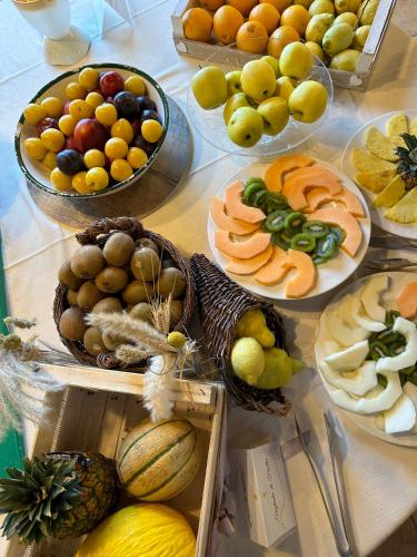 a table filled with plates of fruits and vegetables at Il Borgo Della Marinella in Amantea