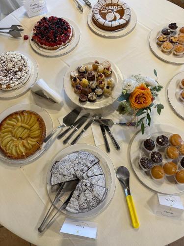 a table topped with plates of desserts and pies at Il Borgo Della Marinella in Amantea