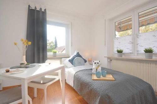 a bedroom with a bed and a table and a desk at BA01-RI Apartment bei Bamberg in Reckendorf