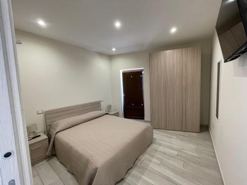a bedroom with a bed and a wooden cabinet at "Da Peppe e Melina" in San Marco dei Cavoti