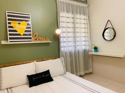 a living room with a white couch and a window at D'Houzz in Sungai Petani