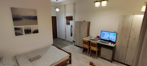 a room with a desk with a computer on it at KEISA APARTRooms in Nowy Sącz