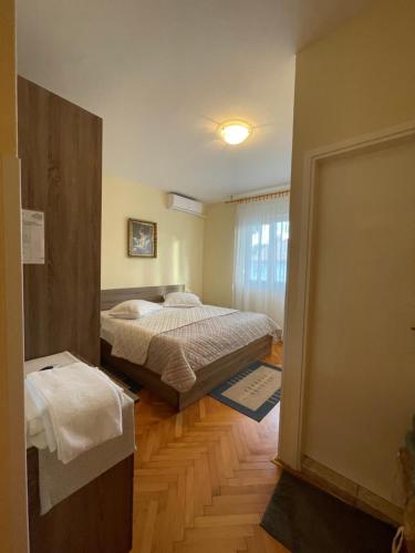 a bedroom with two beds and a window at Rooms Krstinić 84 in Palit