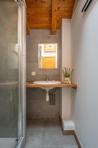 une salle de bain avec un lavabo et un miroir dans l'établissement Chalet Harvey, aux Gets