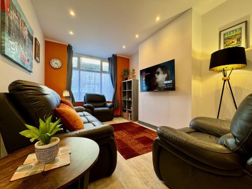 a living room with two couches and a table at Crow Hill House - Tranquil Escape Hideaway in Cleethorpes