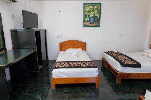 Postel nebo postele na pokoji v ubytování Hotel Las Palmas Cancun Centro