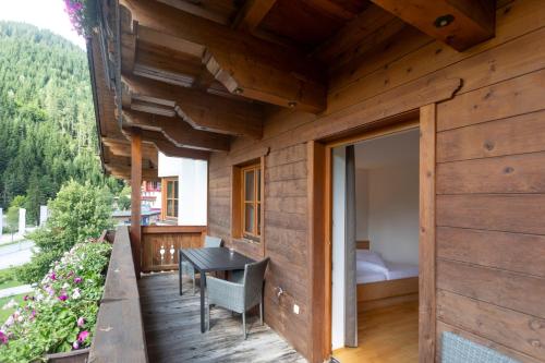 a wooden house with a balcony with a bedroom at Landhaus Zaglauhof in Werfenweng