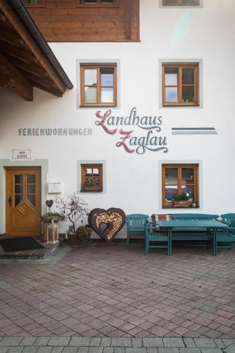 a building with benches and a sign on it at Landhaus Zaglauhof in Werfenweng