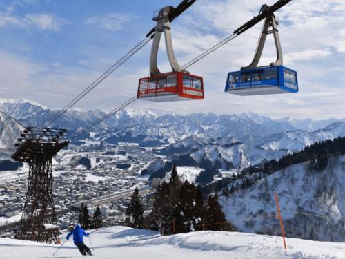 a skier riding a ski lift on a snowy mountain at Shosenkaku Kagetsu in Yuzawa