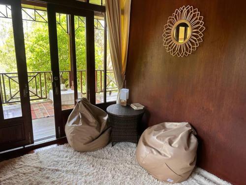 a room with two bean bags in front of a door at Beachfront Bungalow lll in Chaloklum