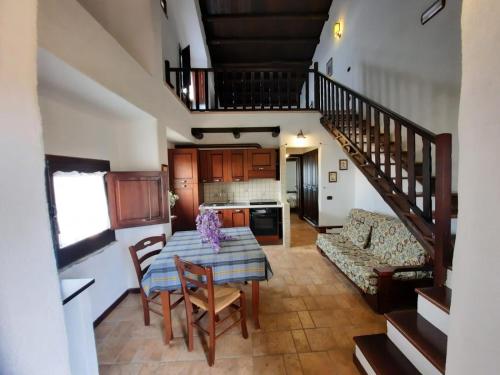 a kitchen and living room with a table and chairs at Il Borgo Della Marinella in Amantea