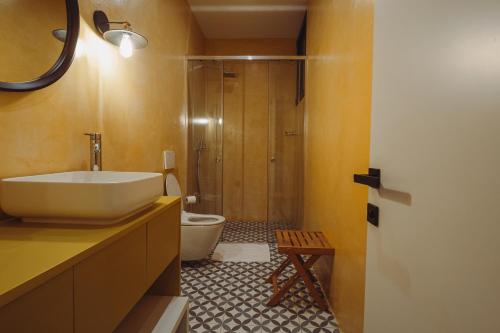 a bathroom with a sink and a toilet at Kronos Hotel in Durrës