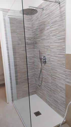 a bathroom with a shower with a glass door at Casa Antonella in Capovalle