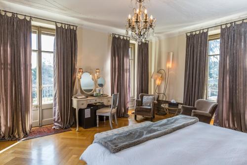 a bedroom with a bed and a vanity and a mirror at La Maison d'Igor in Morges