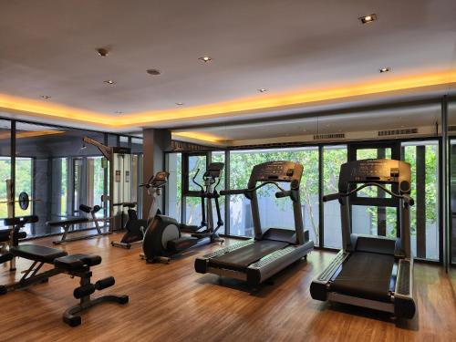 a gym with several treadmills and elliptical machines at Mountain View Suite at The Valley Khaoyai in Ban Huai Sok Noi