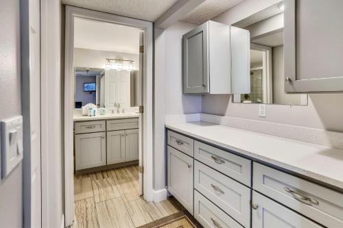 a kitchen with white cabinets and a sink at Emerald Isle 103 in St Pete Beach