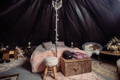 a bedroom with a bed in a tent at Glamping in - luxury tent 