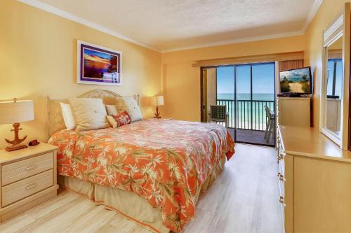 a bedroom with a bed with a view of the ocean at Villa Madeira 410 in St. Pete Beach