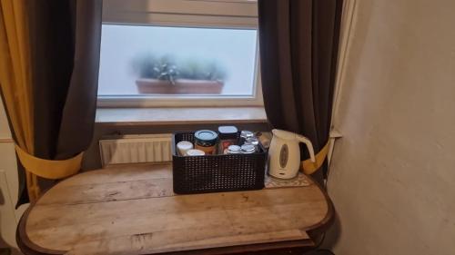 a table in a room with a window at Pension Jeske Heidelberg in Heidelberg