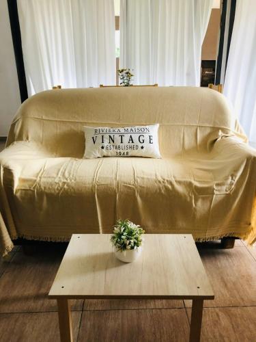 a couch sitting in a living room with a table at Casa El Bosque in Candelaria