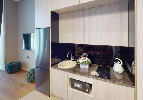 a kitchen with a sink and a refrigerator at Seabreeze, Lighthouse, Baku, Azerbaijan in Baku