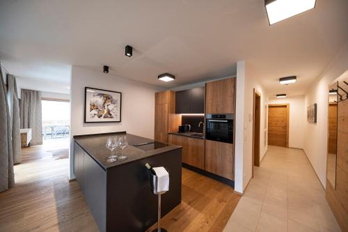 a kitchen with a black island in a room at Lakeside Luxury Apartments in Zell am See