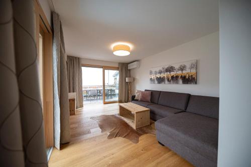 a living room with a couch and a table at Lakeside Luxury Apartments in Zell am See