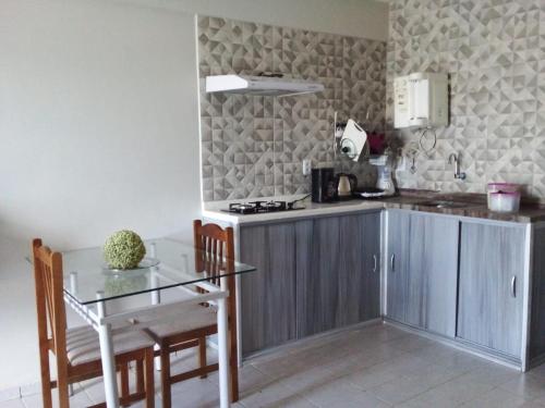 a kitchen with a table and a counter top at Apto 349 Terceira avenida Multishoping Centro Nucleo Bandeirante in Brasilia