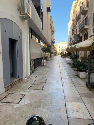 an empty street in a city with buildings at Old Stone House in Bari